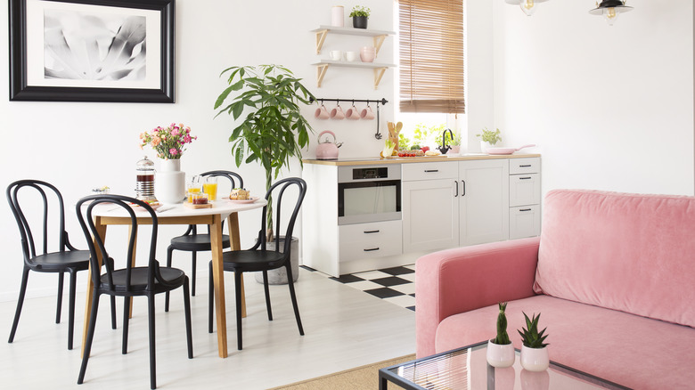 kitchenette with pink sofa and table