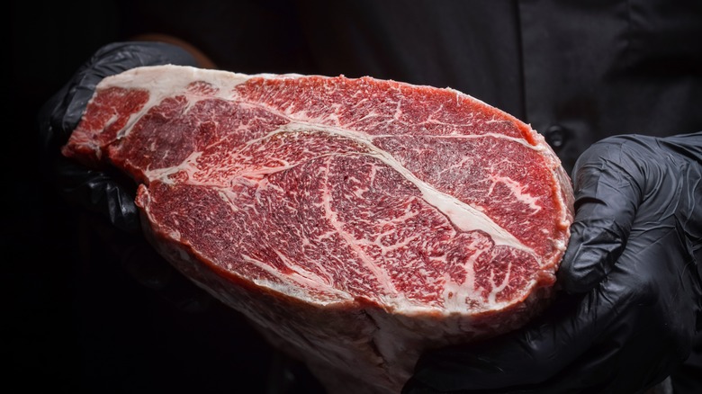 Chef holding a Wagyu steak