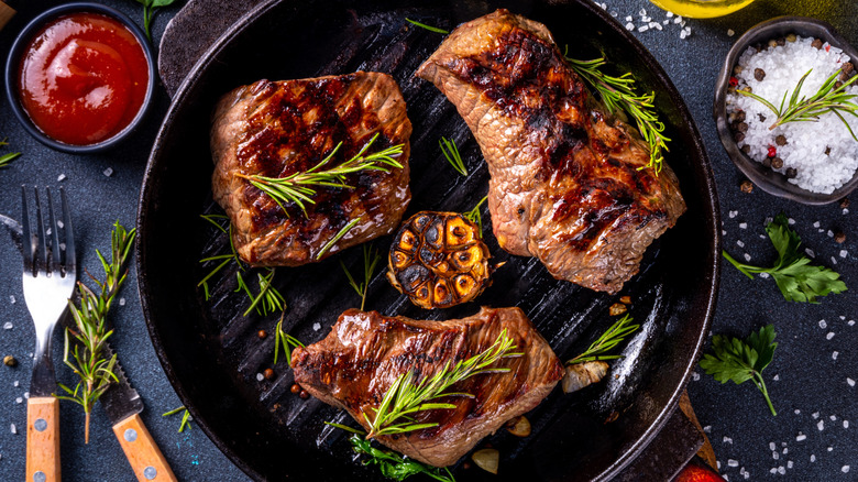 Variety of steak cuts on small grill pan