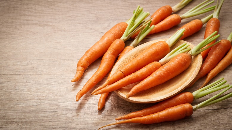 whole carrots with bowl