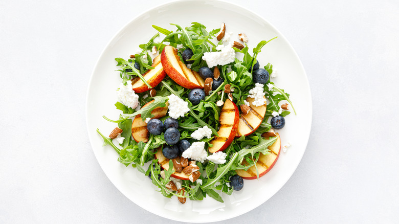 arugula salad with peaches, cheese, blueberries