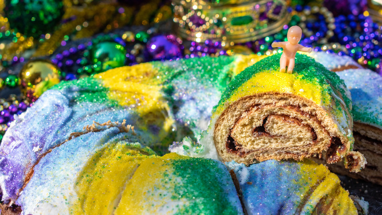 sliced King Cake with plastic baby