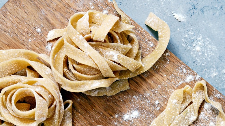 Homemade fettuccine on a wooden board