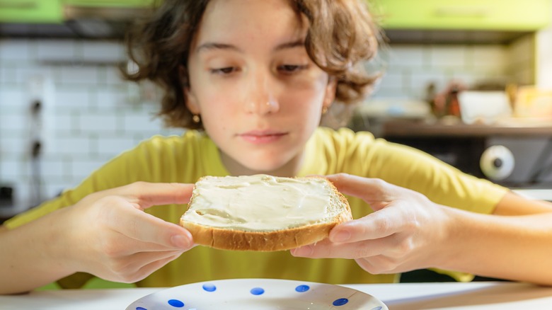 girl eating bread with butter