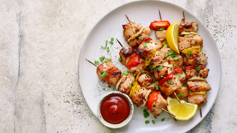 Chicken kebabs on a white plate