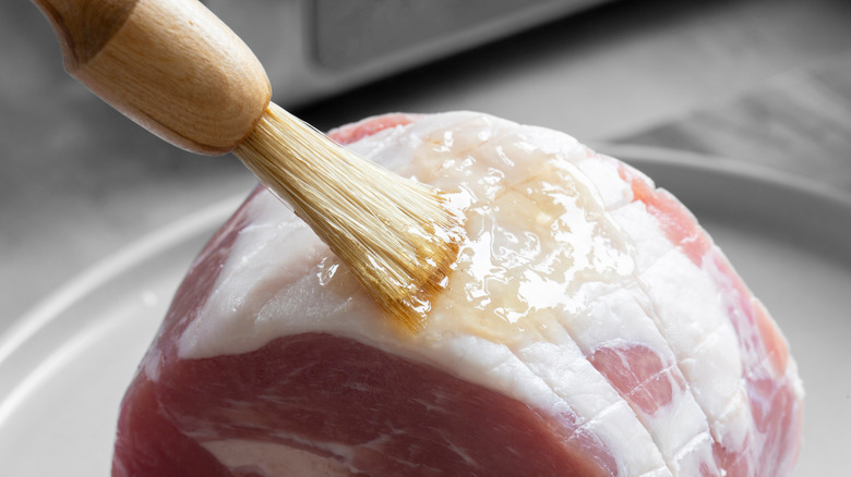 Brushing glaze onto a ham