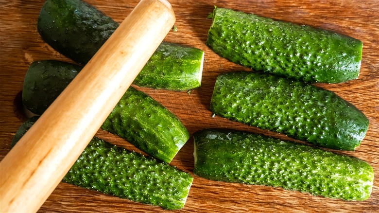 Rolling pin on halved cucumbers 