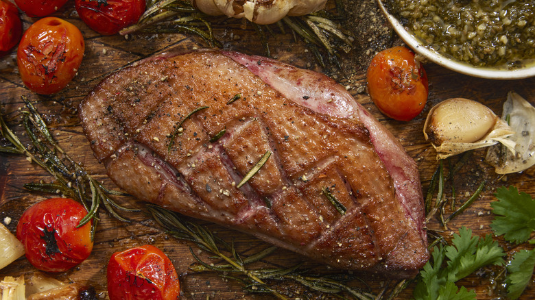 pan seared duck breast with crispy skin and blistered tomatoes and herbs