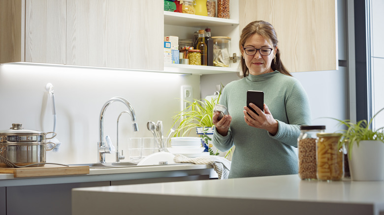 woman checking canned fish