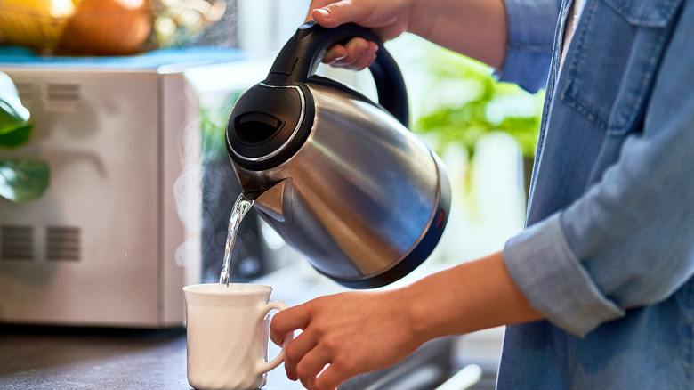 Pouring boiling water into a mug