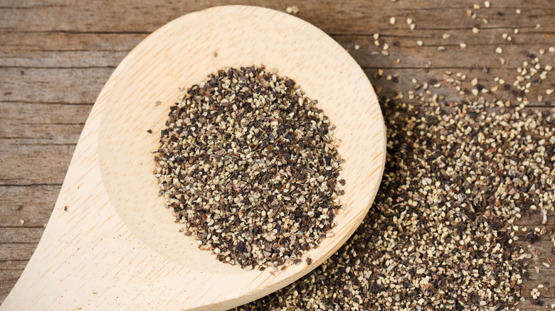 black pepper on wooden spoon