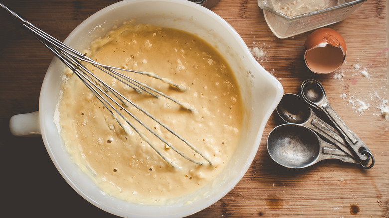 Pancake batter in bowl with whisk