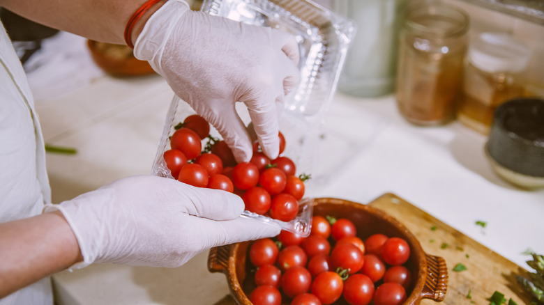 Sorting cherry tomatoes with food-safe gloves
