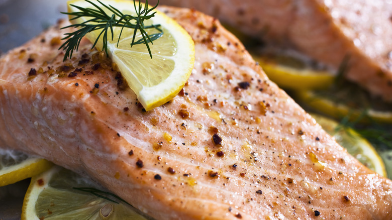 cooked salmon filet with a slice of lemon close up