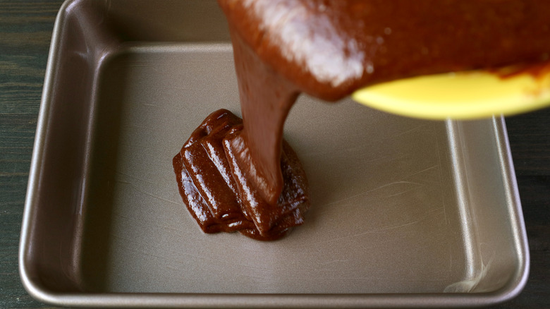 cake batter being poured into a pan