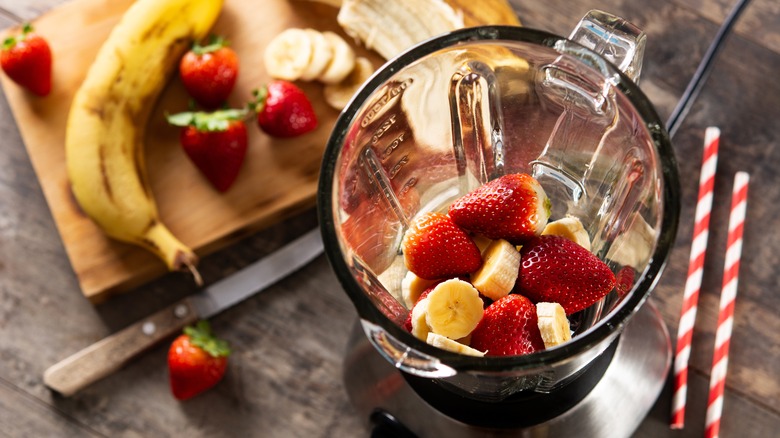 Strawberries and chunks of bananas in a blender