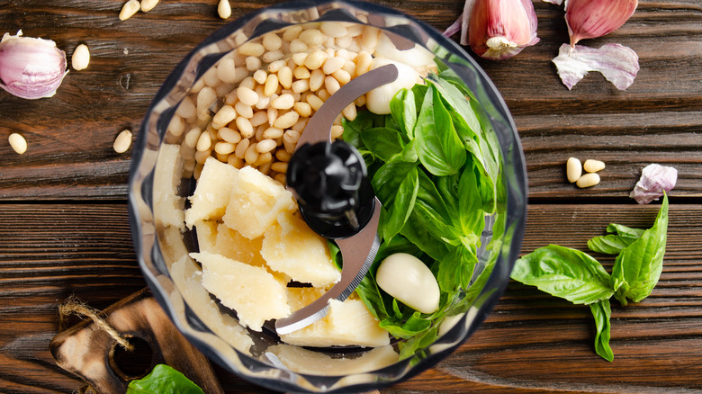 Ingredients for a pesto in a food processor