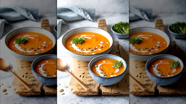 Pumpkin soup garnished with seeds and cream