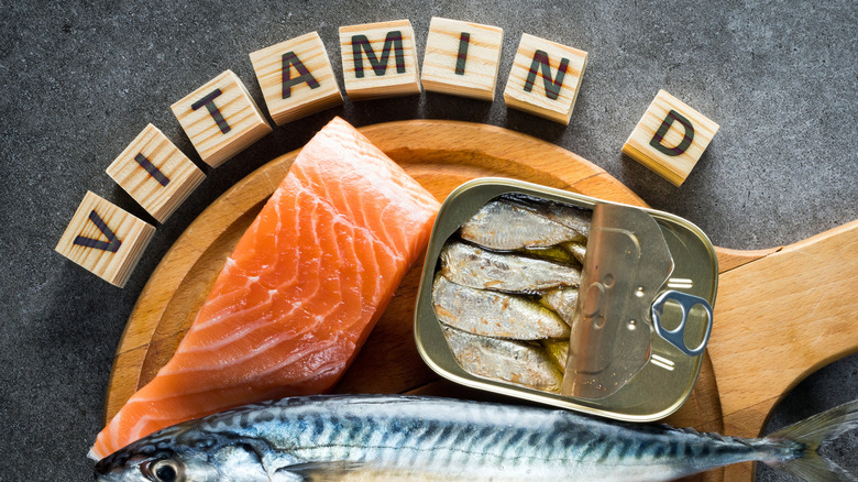 various fish types on wooden board with vitamin d spelled out