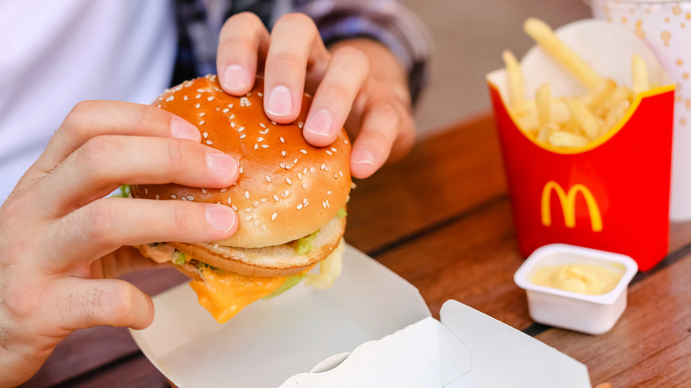 hands on McDonald's burger 