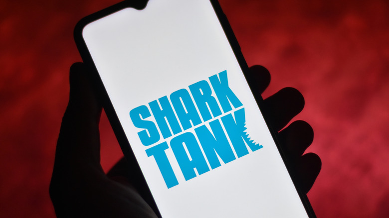 Shark Tank logo on a phone.