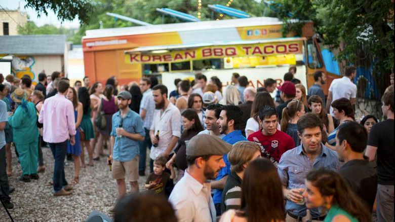 crowd standing near food truck