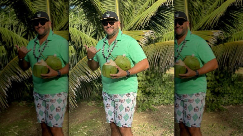 Coco Vinny holding tapped coconuts