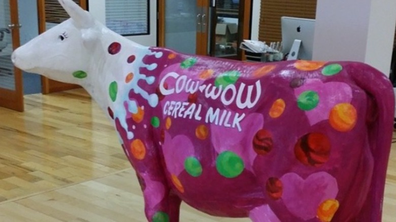 white cow statue decorated with the Cow Wow logo