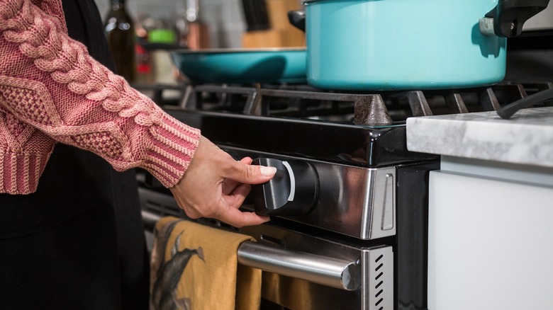 home chef turning stove knob