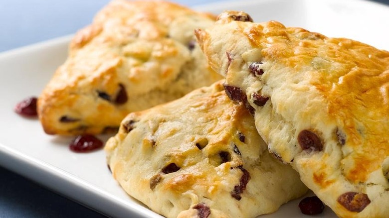 three cranberry scones on plate