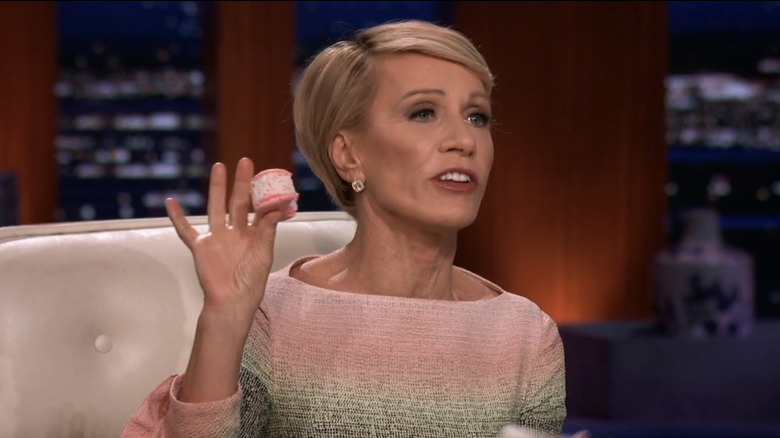 Barbara Corcoran holding a macaron