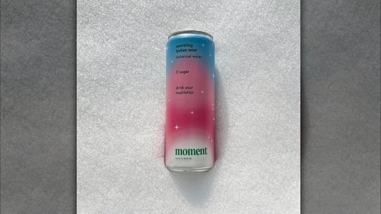 A can of Moment Drink in the snow