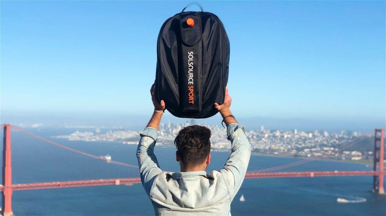 Man holding up SolSource Sport bag