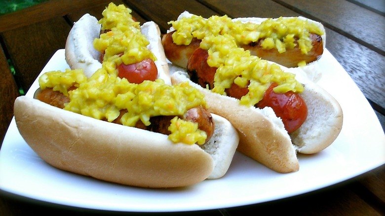 Slawsa on plate of hotdogs