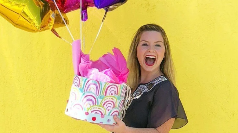 Snarky Tea founder Jenni-Lyn Williams with gifts and balloons