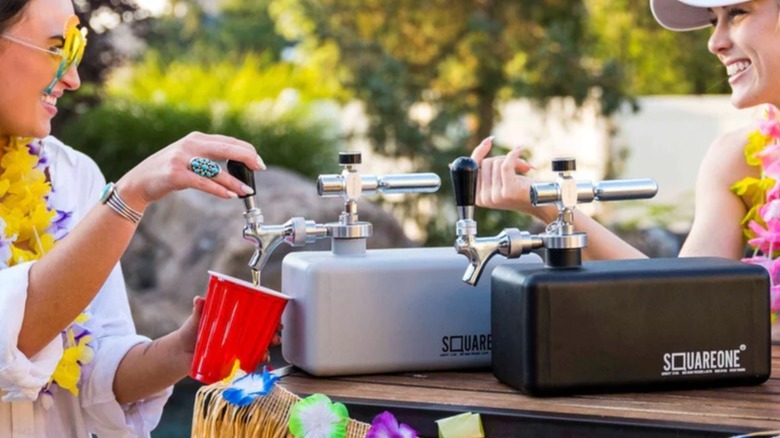 two women pour drinks from Square One Mini Kegs