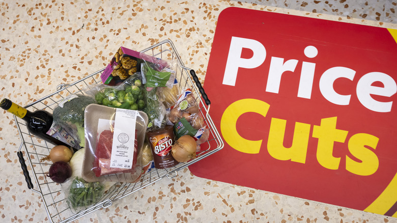 grocery basket beside sale signage