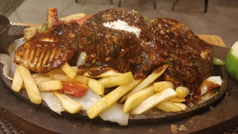 Chicken tikka with gravy and fries