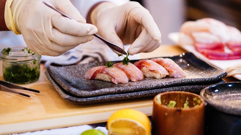 Omakase chef with sushi plate