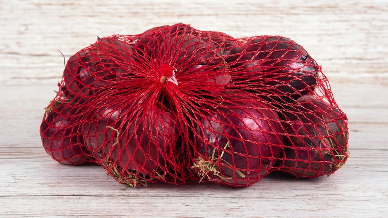 String bag holding red onions