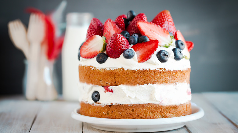 cake layered with thick, fluffy whipped cream and topped with berries