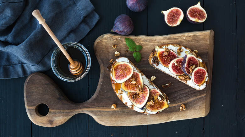 ricotta toast with fig and honey on wooden board