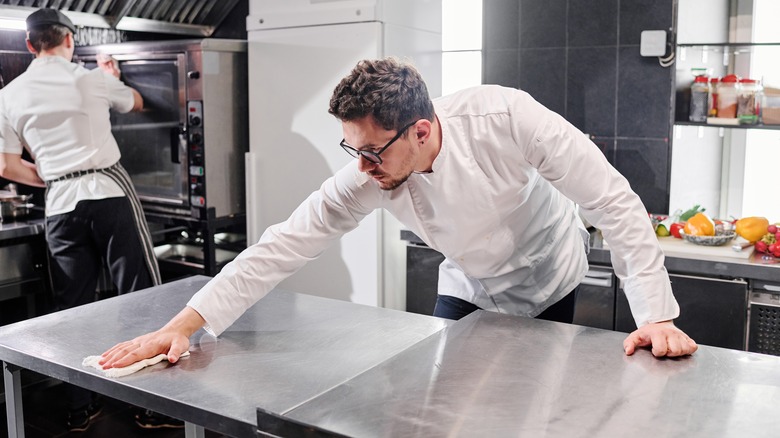 Workers cleaning kitchen