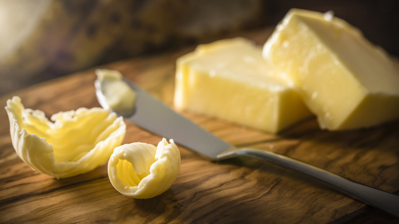 curled slices of butter on board