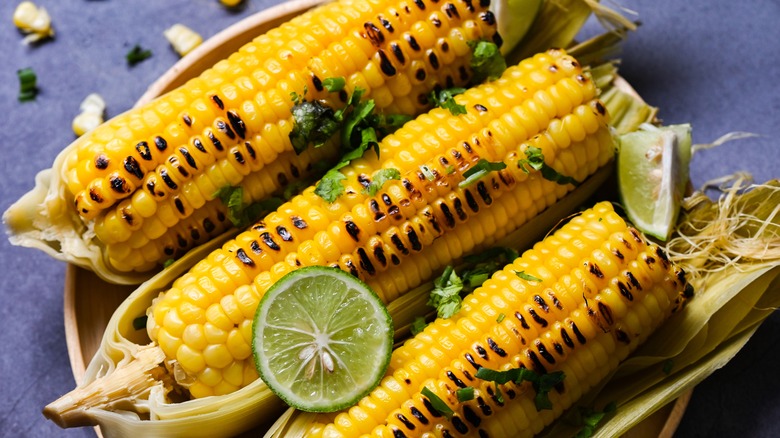 grilled corn in basket with lime