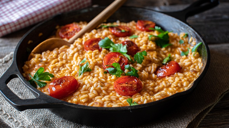 Tomato risotto with wooden spoon