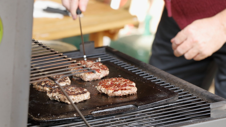 checking food cooking on grill