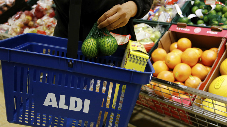 Placing produce in Aldi shopping basket 