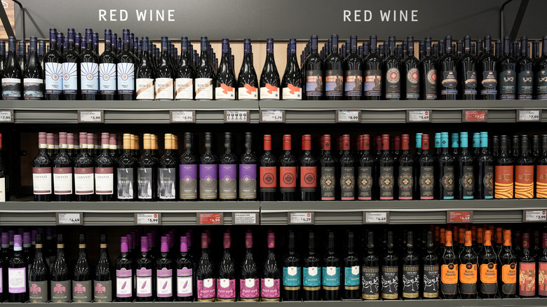 Shelves with red wine bottles