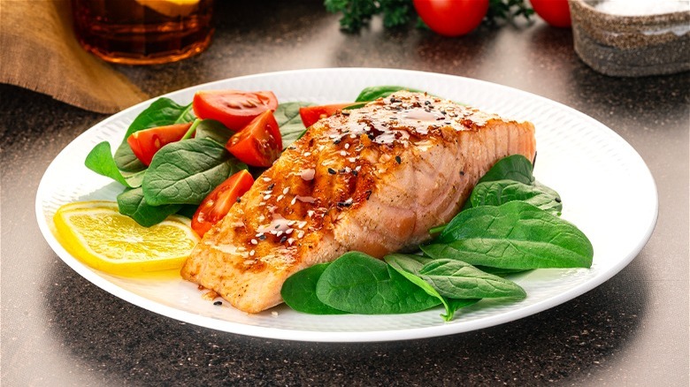 Salmon and spinach on plate